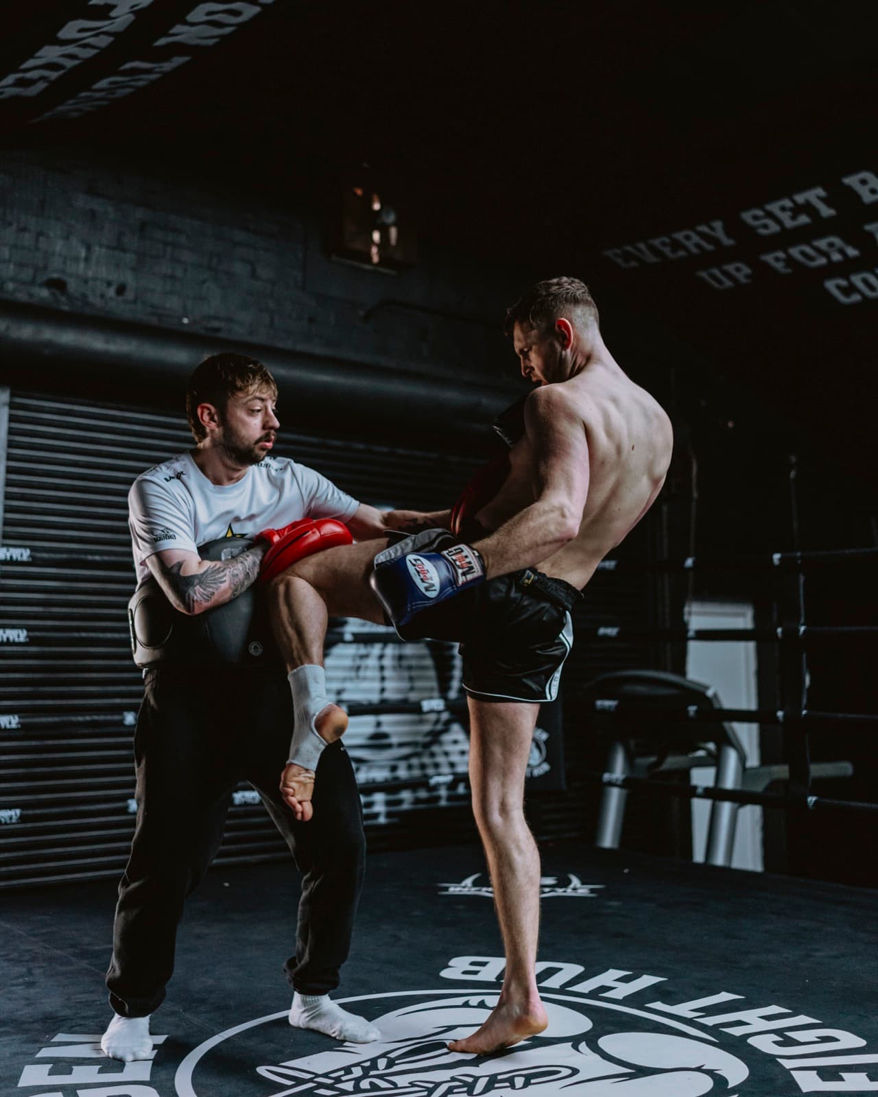 Coaching a fighter through kicks on the pads